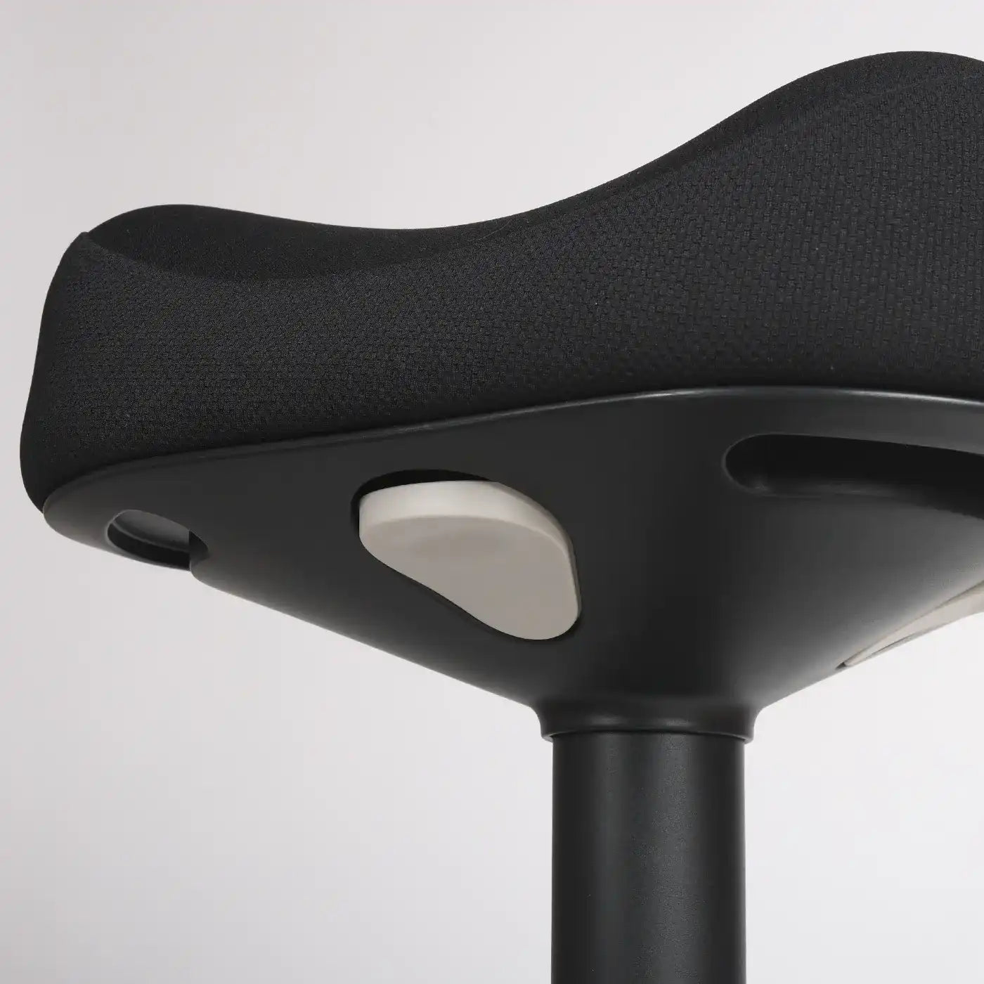 Close-up of a black Wobblez Soothe height adjustable seat with a grey adjustment knob on a gray background
