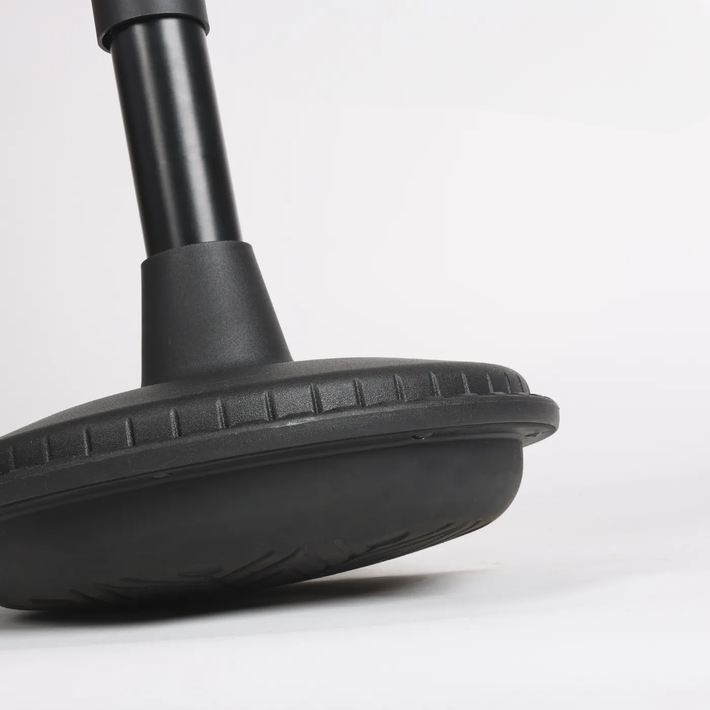 Close-up studio photo of a Wobblez Stable, Settle or Spine heavy wobble stool base tilted with the bottom rubber visible.