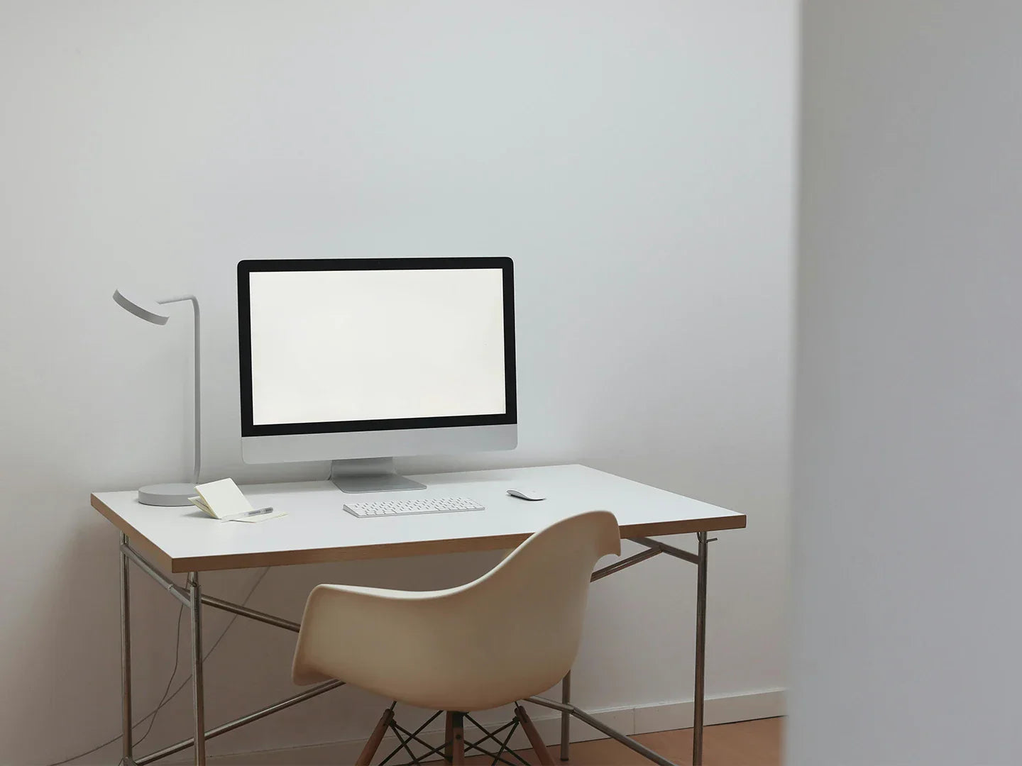 Design chair in white home desk with computer and reading light, not so ergonomic