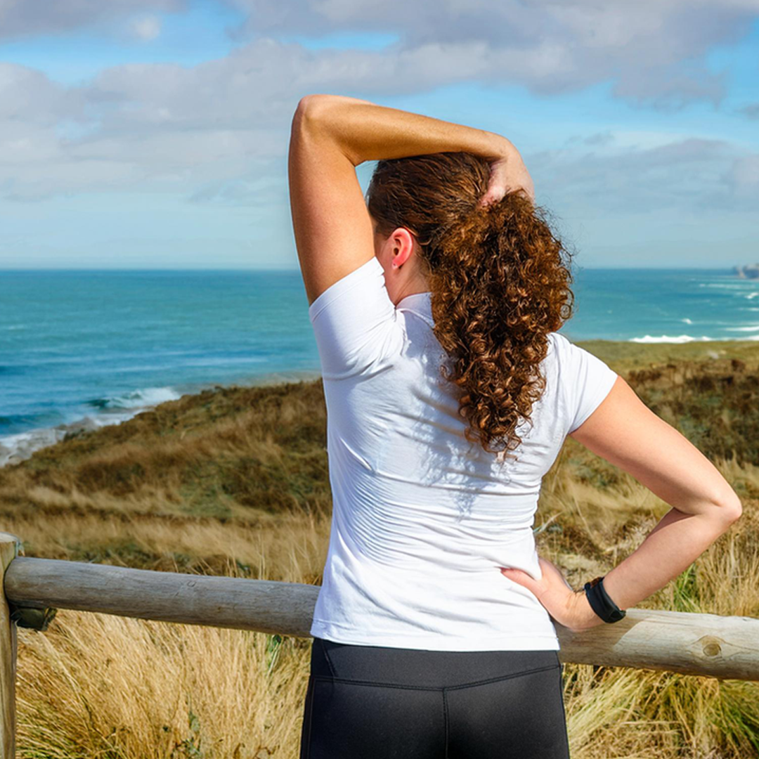 Active woman stretching her back